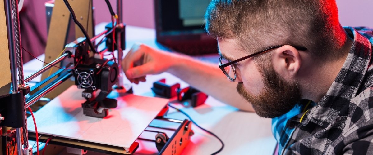Teacher operating 3D printer